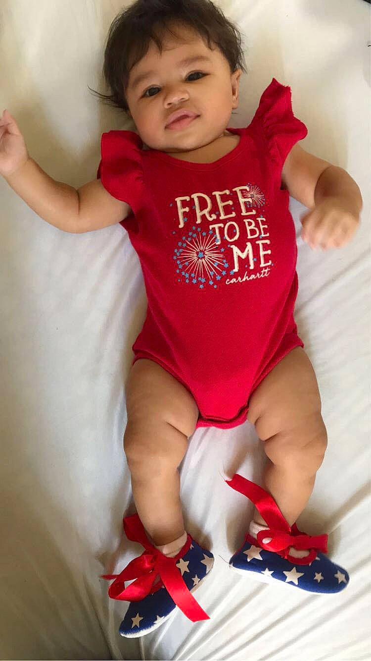 Kaliyah is registered to the contest to win money with this photo: baby, baby_toddler_clothing, cheek, elbow, finger, gesture, happy, human_leg, neck, person, pink, red, shorts, skin, sleeve, t_shirt, thigh, thumb, toddler, trunk