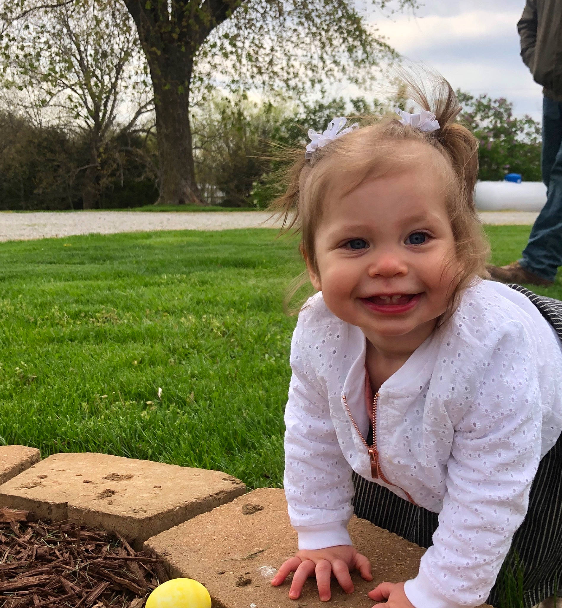Tristin is registered to the contest to win money with this photo: baby, child, easter, facial_expression, fun, grass, joy, lawn, leaf, people, person, plant, play, recreation, sitting, skin, smile, spring, toddler, tree