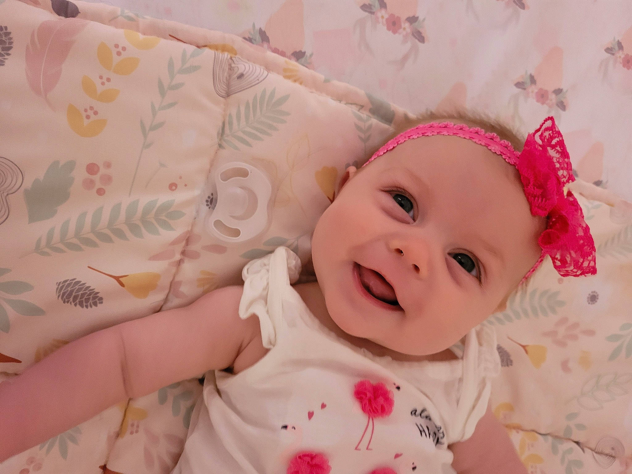 Emmalynn is registered to the contest to win money with this photo: baby, baby_products, baby_toddler_clothing, cheek, face, happy, headgear, headwear, linens, lip, magenta, nose, pattern, peach, person, pink, room, skin, sleeve, smile