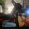 animal, black_dog, blurred_background, companion, cozy, cute, decor, dog, french_bulldog, furniture, home, indoor, pet, portrait, quilt, relaxed, sitting, soft_light, stuffed_animal, toy