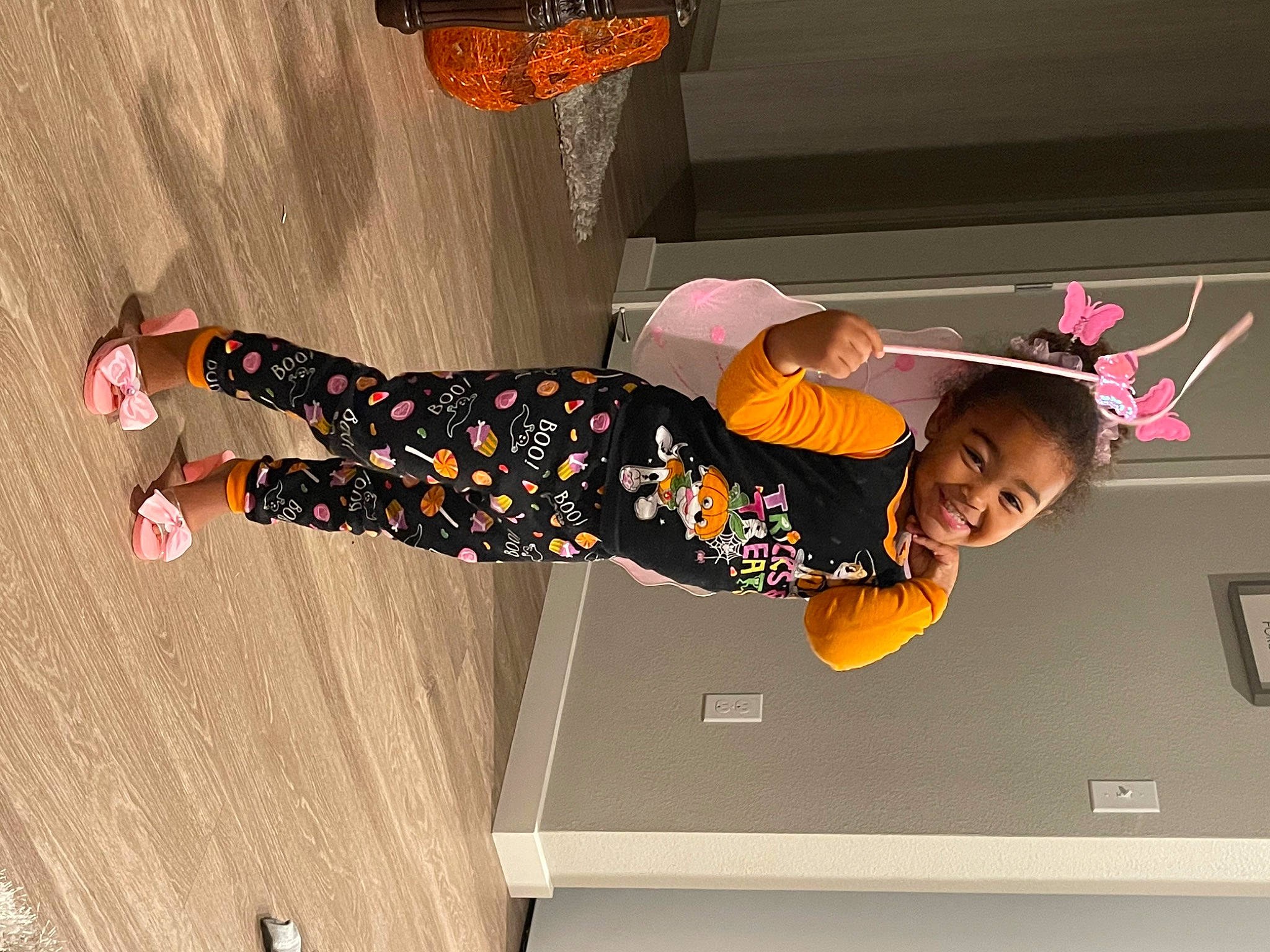 Myla is registered to the contest to win money with this photo: child, display_device, flooring, font, fun, graphics, happy, hat, human_leg, joy, knee, orange, person, room, smile, sock, thigh