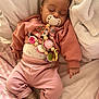baby, infant, newborn, child, sleeping, pacifier, pacifier_clip, pink_clothing, crochet_toy, beads, blanket, pillow, bed, onesie, socks, hand, closed_eyes, cute, cozy, portrait