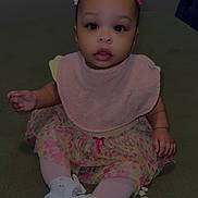 Desire is registered to the contest to win money with this photo: baby, child, infant, sitting, pink_bib, floral_skirt, white_shoes, hair_clips, green_carpet, star_snacks, indoors, window, blinds, curious_expression, cute, small_hands, colorful, decorations, floor, portrait