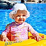 baby, blue, child, floating, happy, inflatable_ring, leisure, outdoor, person, pink_swimsuit, recreation, smiling, summer, sun_hat, sunny, swimming_pool, toddler, vacation, water, yellow