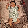newborn, baby, infant, sleeping, portrait, crib, blanket, pink, polka_dot, onesie, clothing, face, arms, legs, cozy, nursery, bedtime, indoors, mesh, soft_lighting