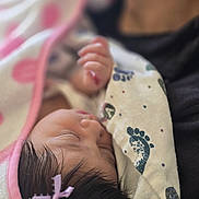 Mía Julieta Pulido joined the competition — help win amazing prizes! baby, infant, sleeping, portrait, close_up, blanket, pink, bundled, hand, face, hair, bow, indoors, cozy, peaceful, resting, textile, pattern, soft_lighting, family_photo