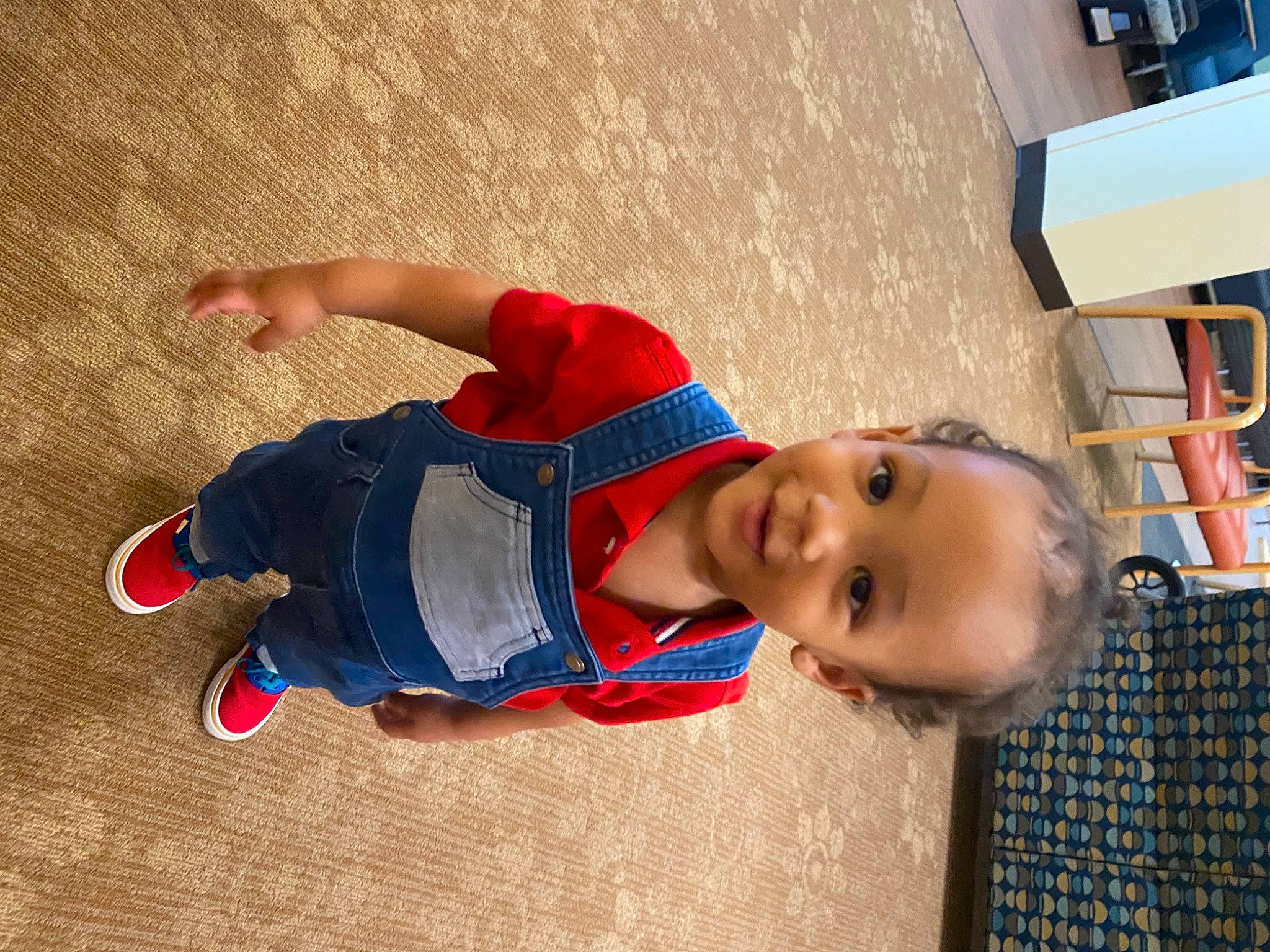 Tre is registered to the contest to win money with this photo: baby, baby_laughing, baby_toddler_clothing, child, electric_blue, flooring, fun, happy, hat, headgear, joy, leisure, pattern, person, play, recreation, shelf, shelving, smile, t_shirt