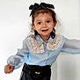 Ella participe au concours pour gagner de l'argent avec cette photo : black_bow, black_skirt, blue_blouse, buttoned_shirt, child, cute, fashion, girl, happy, indoor, innocent, lace_collar, light_background, long_sleeves, person, playful, portrait, smiling, standing, young_child