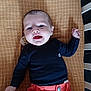 baby, baby_gear, bed, black_shirt, blanket, child, clothing, coral_pants, crib, cute, face, hands, happy, head, indoors, infant, lying_down, pacifier, person, smiling