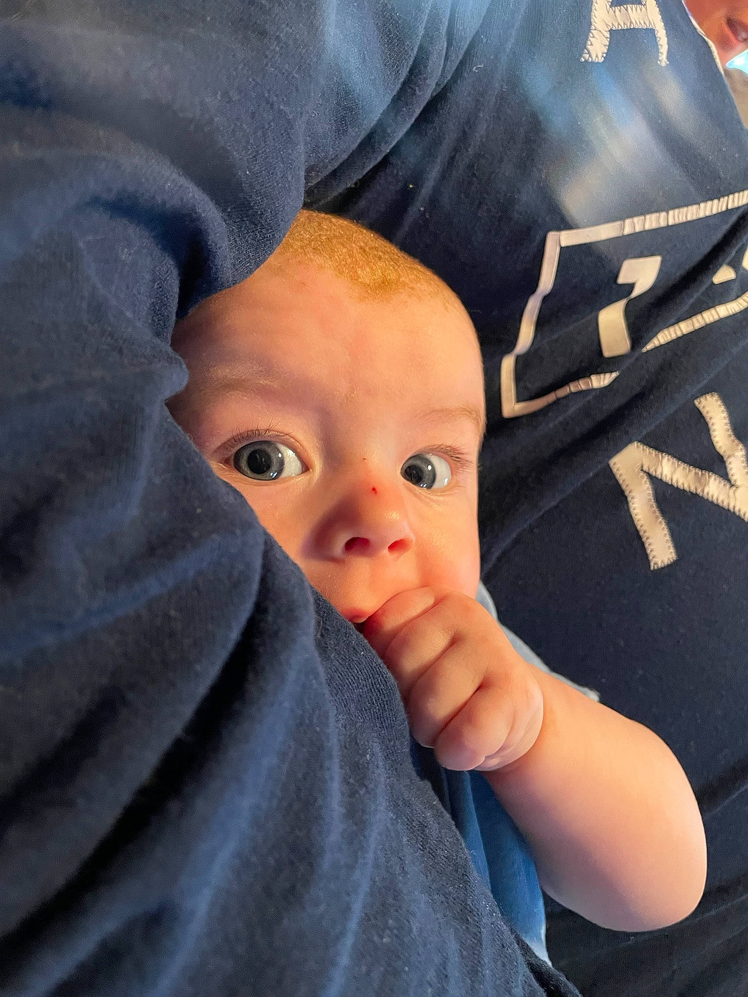 Orion is registered to the contest to win money with this photo: baby, baby_toddler_clothing, cheek, child, comfort, electric_blue, eyebrow, eyelash, finger, gesture, happy, iris, linens, nail, nose, person, skin, sleeve, thumb, toddler