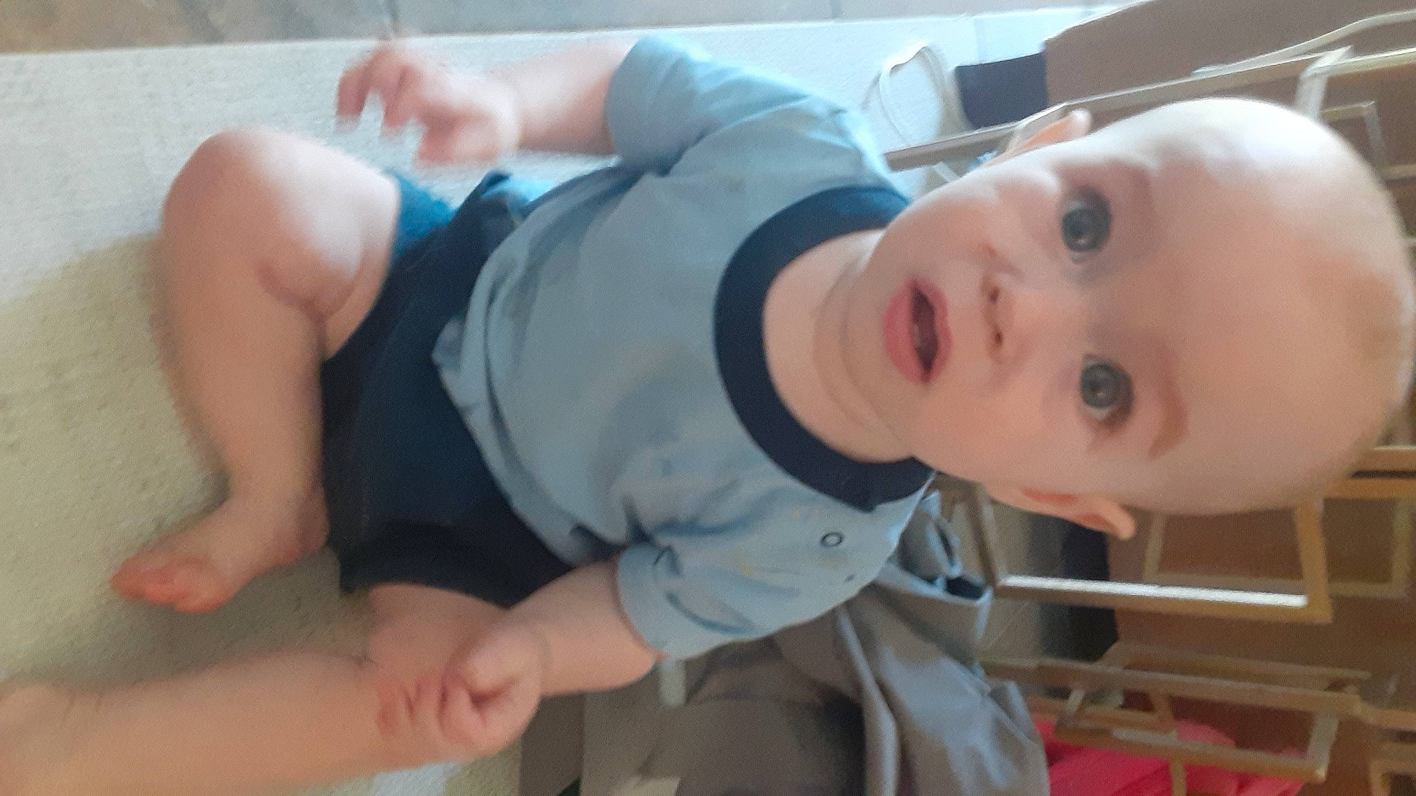 Orion is registered to the contest to win money with this photo: baby, baby_toddler_clothing, cheek, chest, child, comfort, elbow, finger, gesture, hand, human_body, joint, knee, mouth, neck, nose, person, skin, sleeve, surprise