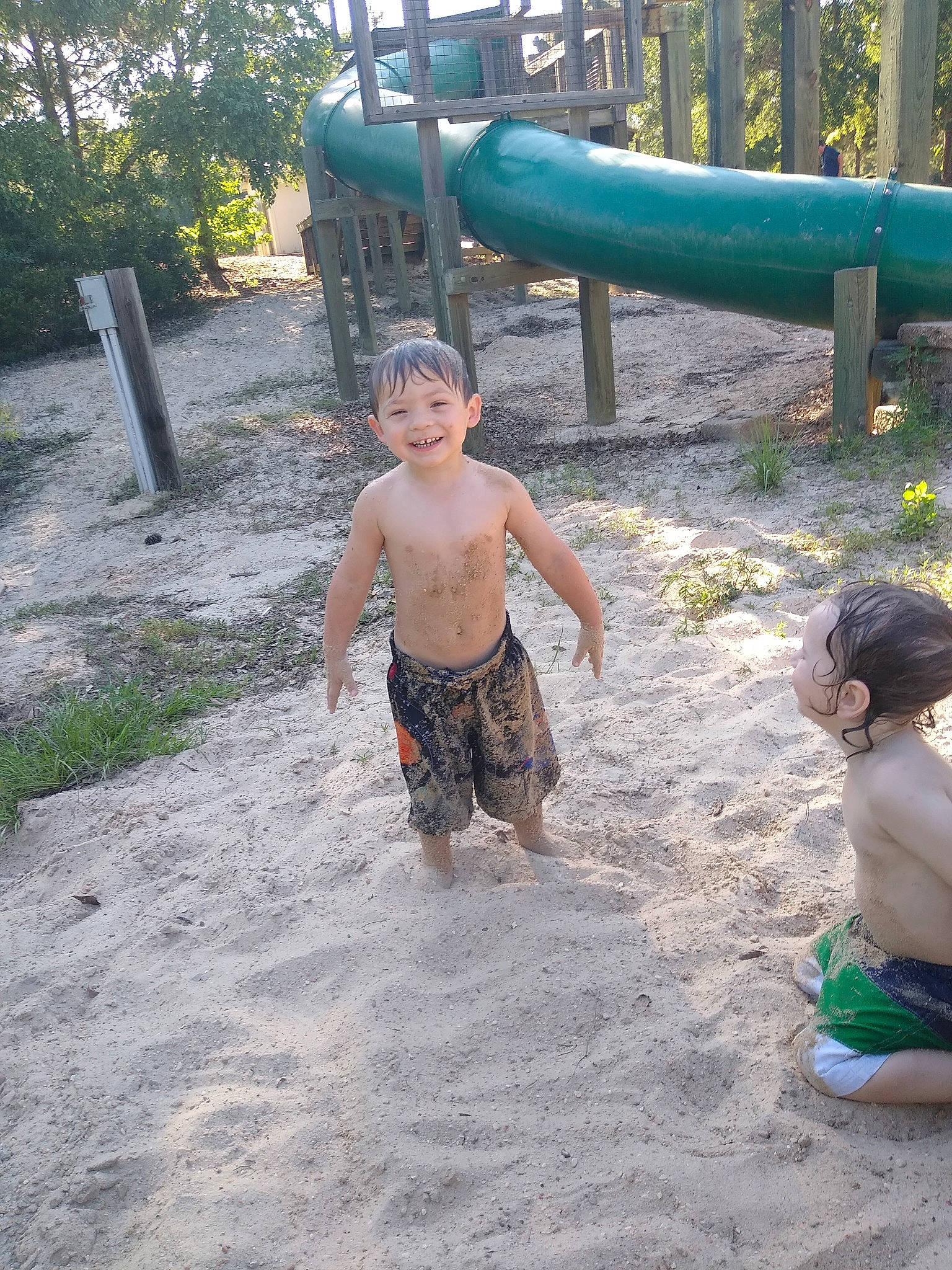 Ezekiel is registered to the contest to win money with this photo: child, fun, joy, leisure, mud, outdoor_play_equipment, person, play, playground, public_space, recreation, summer, vacation, water, water_park