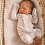Luca joined the competition — help win amazing prizes! newborn, baby, sleeping, onesie, white_clothing, moon_pattern, star_pattern, blanket, woven_basket, cozy, soft_texture, peaceful, infant, cute, resting, indoors, closeup, foot, face, child