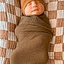 baby, sleeping, swaddle, hat, blanket, cozy, infant, cute, resting, child, soft, brown, checkered, fabric, newborn, portrait, peaceful, indoors, comfort, wrapped