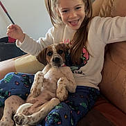 Athena participe au concours pour gagner de l'argent avec cette photo : animal, armchair, child, cozy, cute, dog, furniture, girl, hair, happy, home, indoor, pajamas, person, pet, playful, puppy, relaxed, smiling, young