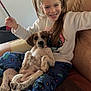 animal, armchair, child, cozy, cute, dog, furniture, girl, hair, happy, home, indoor, pajamas, person, pet, playful, puppy, relaxed, smiling, young