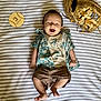 Easton Jo is registered to the contest to win money with this photo: 3_months, baby, baseball_glove, brown_shorts, casual, child, clothing, cute, footwear, happy, indoor, infant, lying_down, milestone_marker, person, portrait, smiling, striped_blanket, tropical_shirt, young