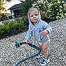 Sawyer is registered to the contest to win money with this photo: baby, blue_eyes, child, cute, daylight, flowers, garage, garden, garden_hose, gravel, hoodie, house, hydrangea, landscaping, outdoor, portrait, sneakers, standing, toddler, water_nozzle