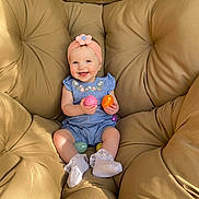 Avery joined the competition — help win amazing prizes! baby, child, smiling, headband, flower, easter_eggs, colorful, blue_dress, sitting, cushion, chair, beige, happy, indoors, cute, sock, white_sock, soft_lighting, portrait, person