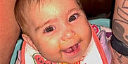 Serenity is registered to the contest to win money with this photo: baby, smiling, bib, watermelon, face, child, happy, infant, person, cute, tattoo, arm, skin, mouth, teeth, eyes, clothing, closeup, cheeks, expression