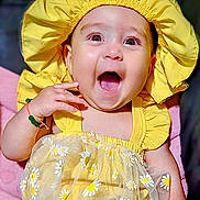 Serenity joined the competition — help win amazing prizes! baby, child, yellow_clothing, bonnet, smiling, happy, tutu, floral_pattern, cute, infant, portrait, sitting, bracelet, hand, face, bright_colors, cheerful, cute_outfit, closeup, adorable