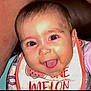 Serenity is registered to the contest to win money with this photo: baby, smiling, bib, face, child, happy, mouth_open, clothing, person, infant, closeup, cute, expression, seat, colorful, cheerful, indoor, skin, head, eyes
