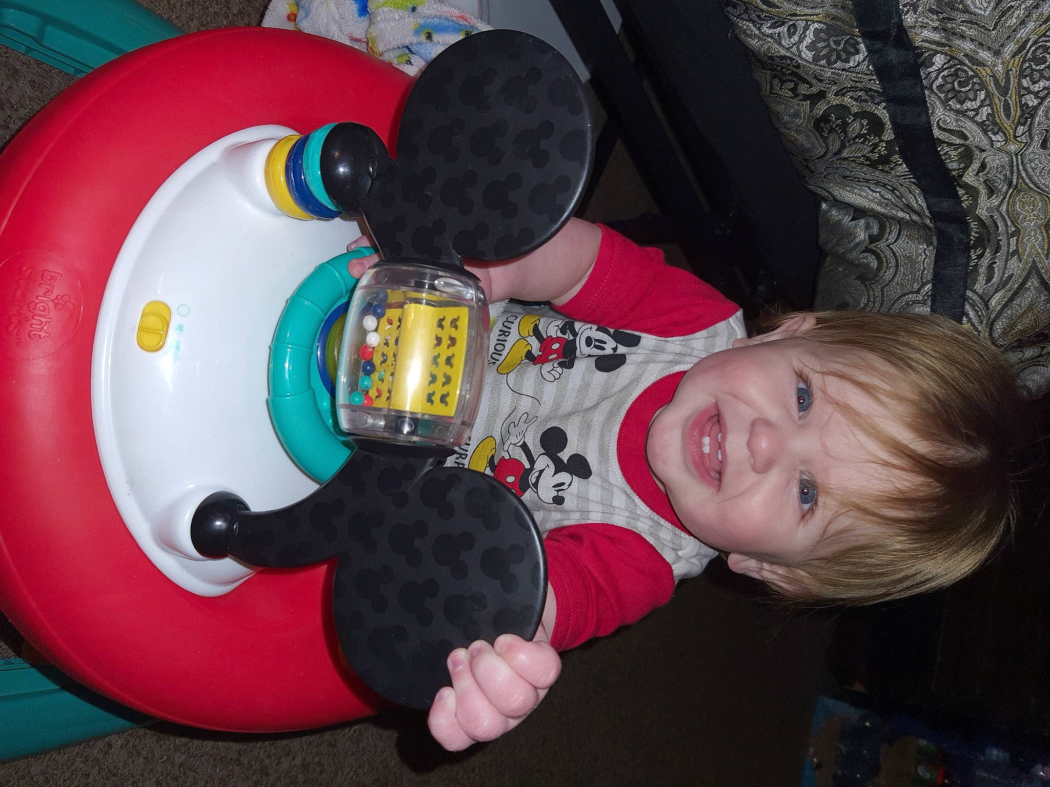 Xavier is registered to the contest to win money with this photo: baby, baby_products, baby_toddler_clothing, baby_toys, child, circle, drum, fun, idiophone, leisure, machine, mammal, musical_instrument, person, plastic, play, recreation, sitting, smile, toddler