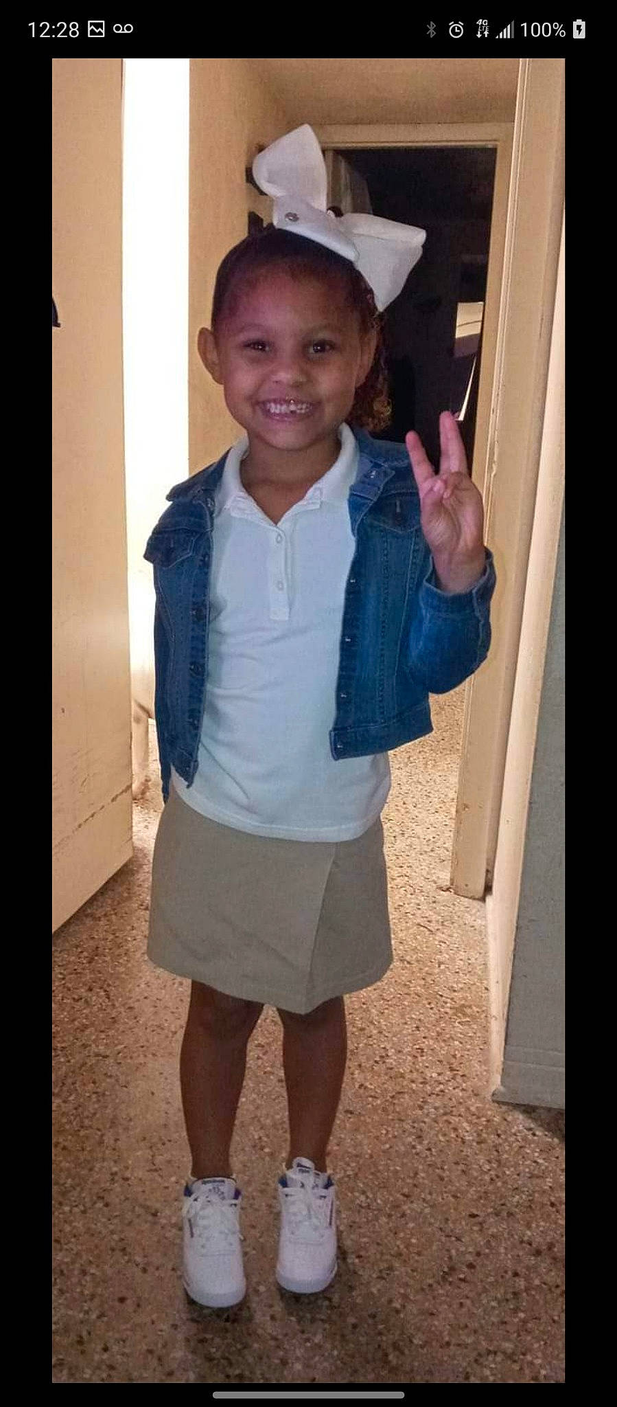 Mariyah is registered to the contest to win money with this photo: baby_toddler_clothing, collar, dress_shirt, gesture, hairstyle, happy, joint, joy, leg, neck, person, school_uniform, shorts, shoulder, skin, sleeve, smile, standing, street_fashion, t_shirt