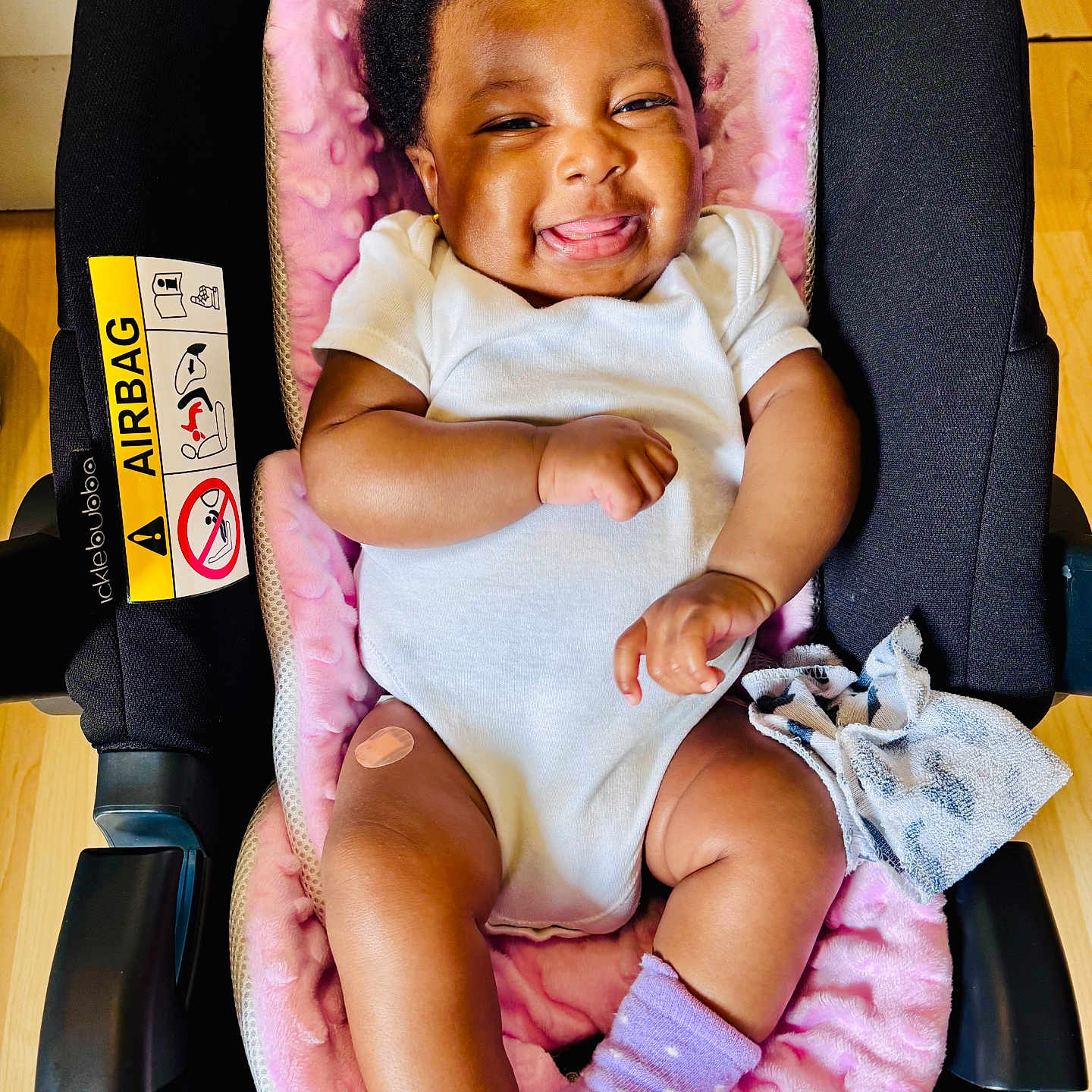 Bethel joined the competition — help win amazing prizes! adorable, baby, bandage, car_seat, child, closeup, cloth, comfort, cute, happy, indoor, infant, person, pink_blanket, purple_socks, seat, smile, tongue_out, white_onesie, wooden_floor