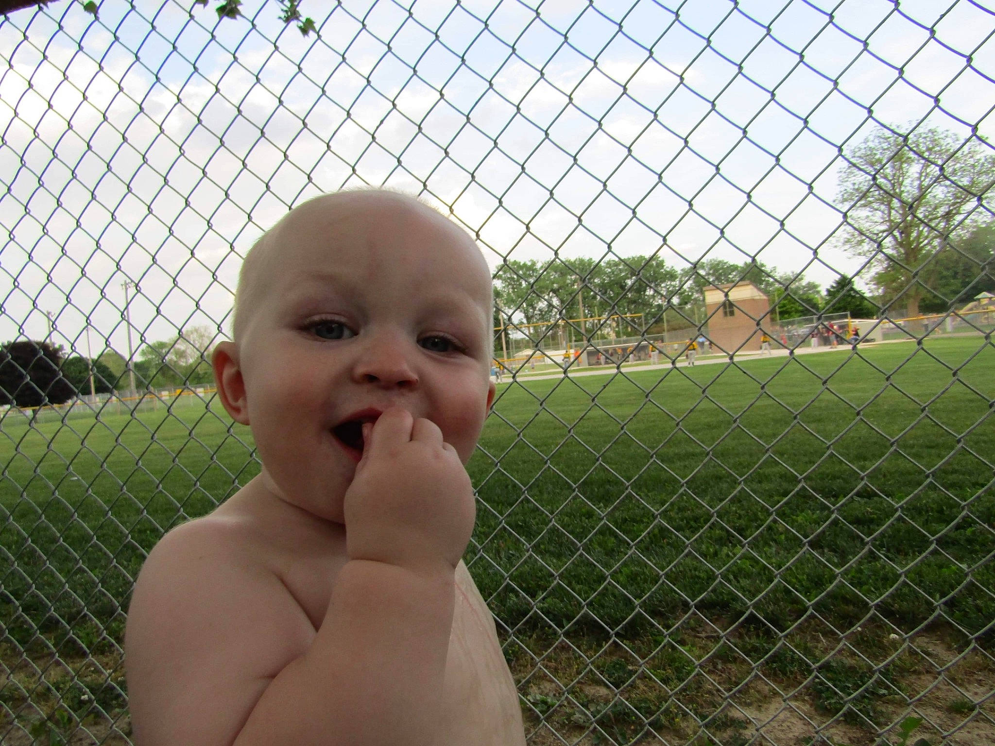 Kolby joined the competition — help win amazing prizes! chin, eye, fence, finger, grass, hand, happy, head, human_body, leisure, line, mesh, nose, person, plant, sky, smile, thumb, toddler, tree
