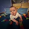 Vernon joined the competition — help win amazing prizes! baby, child, toy, indoor, crawling, blue_carpet, colorful, cushion, wooden_drawer, curious, face, person, clothing, play, early_childhood, smiling, floor, room, furniture, infant