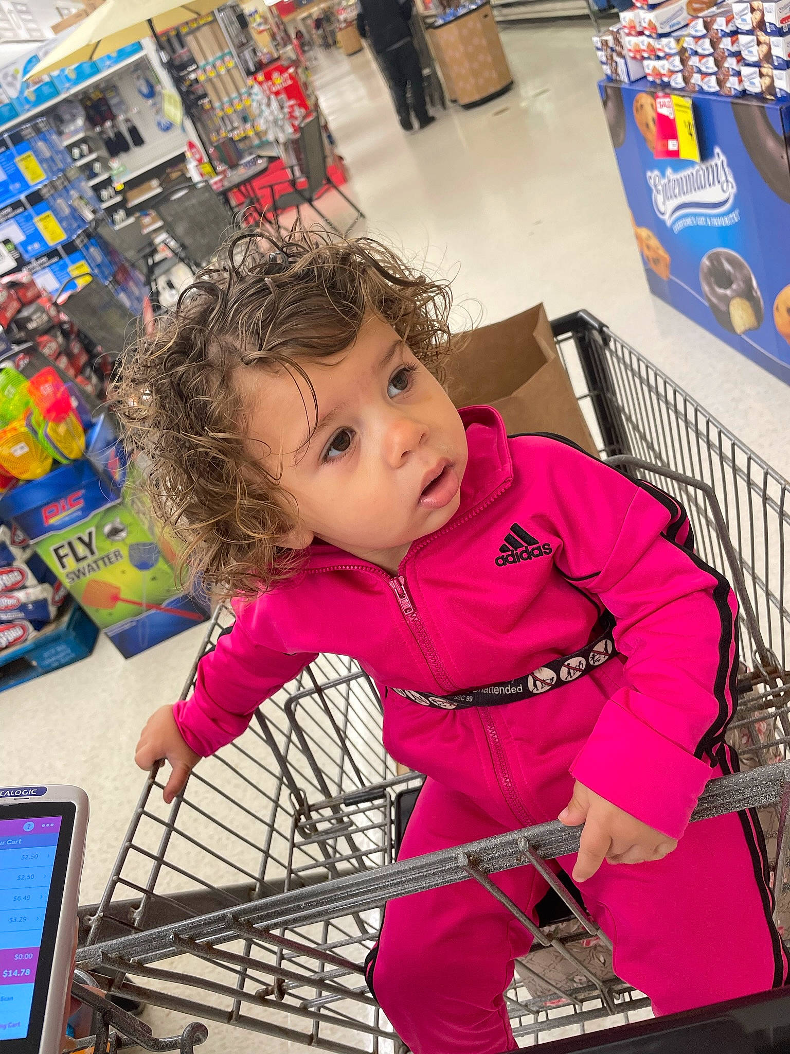 Ellee is registered to the contest to win money with this photo: bag, child, computer_keyboard, convenience_store, customer, event, flooring, fun, grocery_store, leisure, luggage_and_bags, magenta, person, product, retail, service, shopping, shopping_cart, sitting, t_shirt