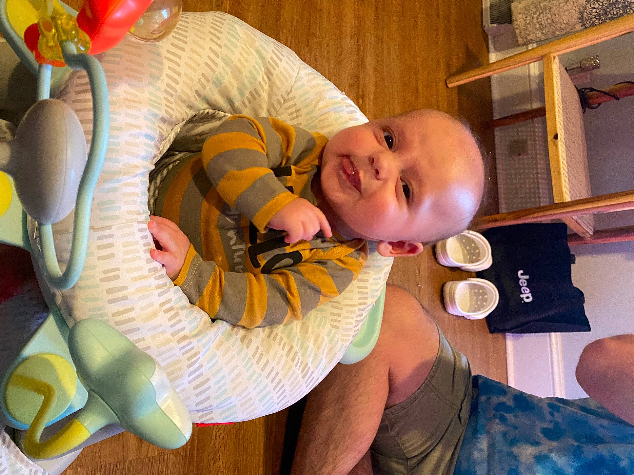 Beau is registered to the contest to win money with this photo: baby, baby_products, baby_toddler_clothing, child, comfort, event, finger, fun, happy, lap, mouth, person, play, room, sitting, smile, thumb, toddler, toy, tree