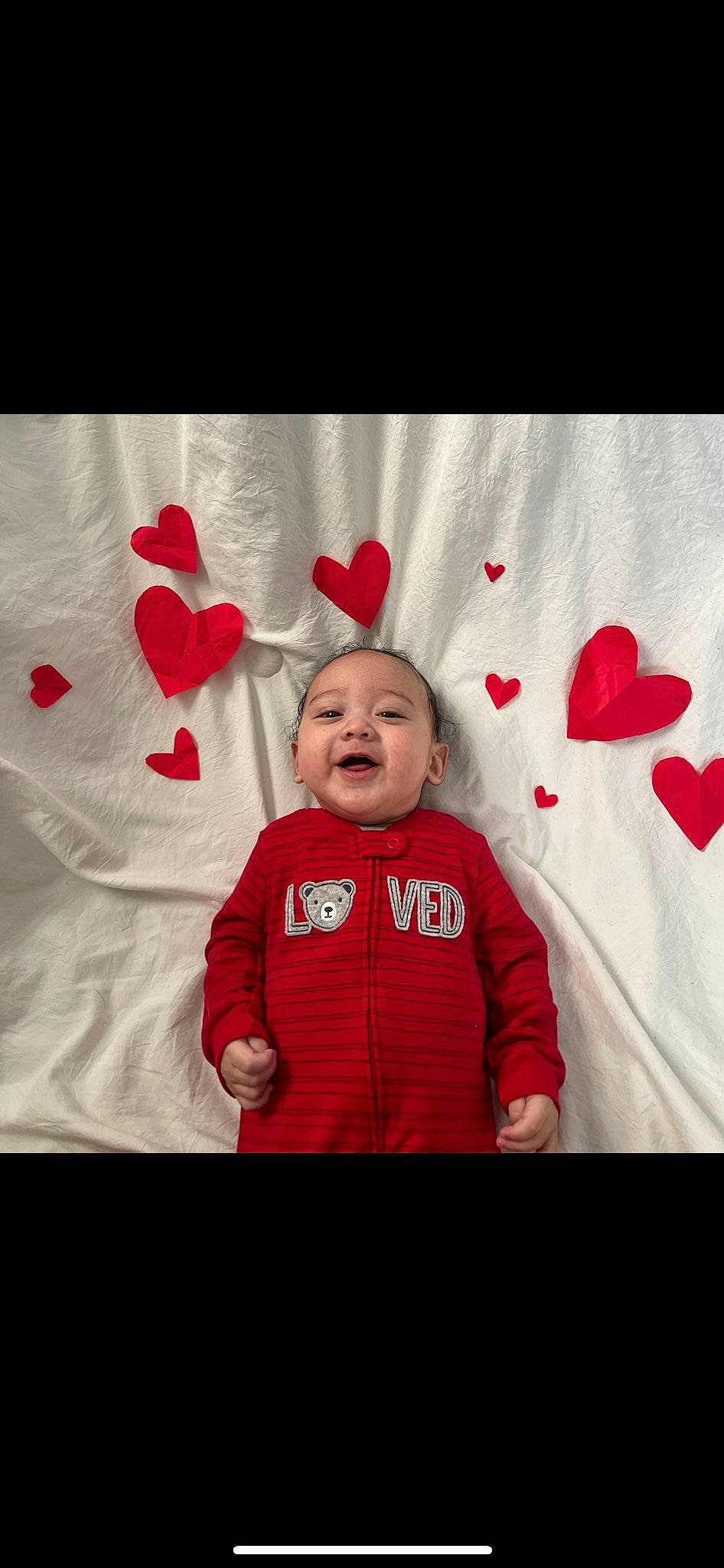Derrick is registered to the contest to win money with this photo: baby, baby_toddler_clothing, carmine, child, christmas, christmas_eve, event, fur, happy, holiday, hood, love, magenta, person, red, room, sleeve, smile, t_shirt, textile