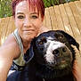 woman, dog, outdoor, fence, tree, pet, portrait, smile, sunlight, closeup, black_dog, collar, happy, casual, nature, daylight, person, red_hair, animal, backyard