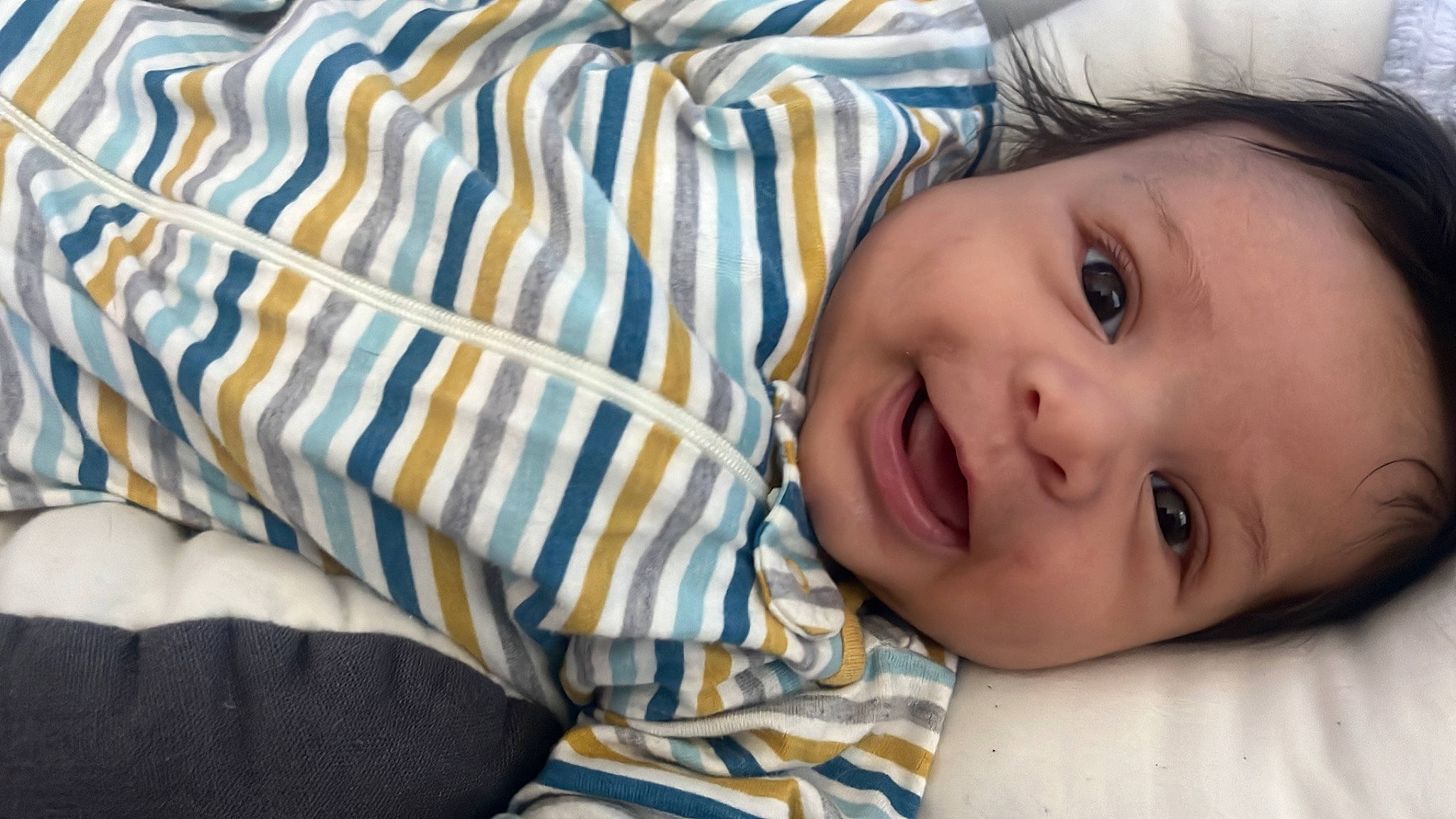 Anthony is registered to the contest to win money with this photo: cheek, comfort, eye, eyebrow, eyelash, face, happy, head, iris, lip, mouth, nose, person, plaid, plant, skin, sleeve, smile, textile, toddler