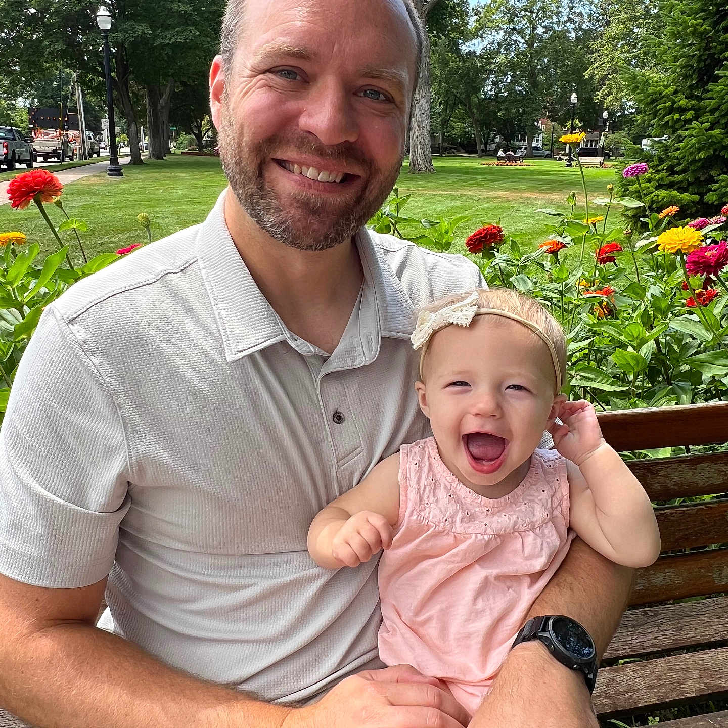 Lucy joined the competition — help win amazing prizes! man, baby, child, smiling, outdoor, park, bench, flowers, nature, greenery, happy, family, portrait, casual_clothing, headband, sunlight, daytime, person, grass, tree