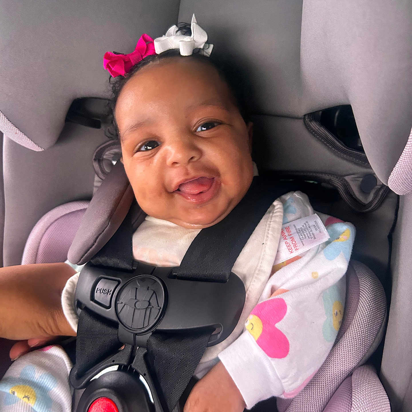 Ahziyla is registered to the contest to win money with this photo: baby, baby_girl, bows, car_seat, child, closeup, clothing, colorful, cute, cute_outfit, face, happy, indoors, infant, person, portrait, safety, seat, seatbelt, smiling
