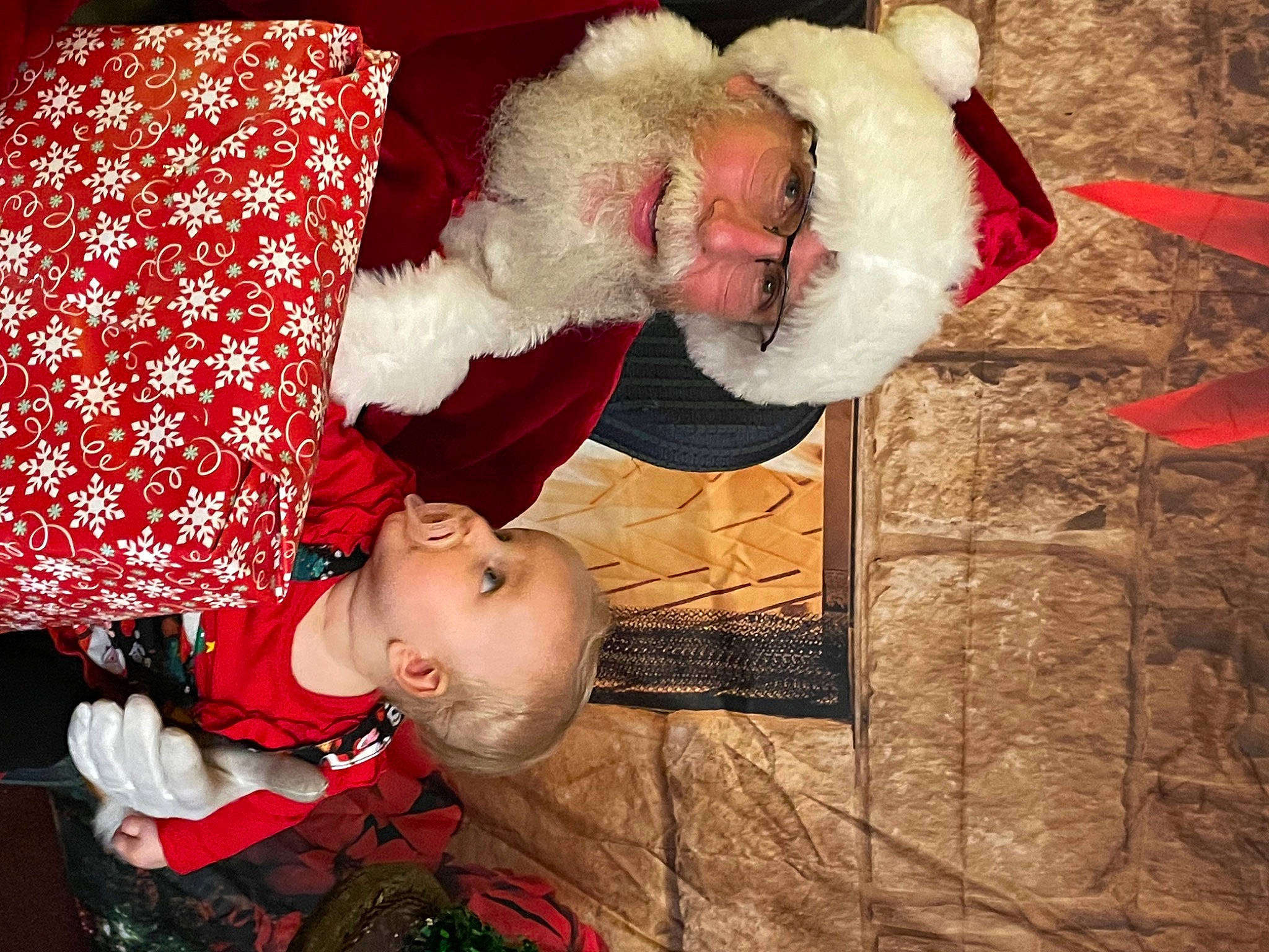 Briella is registered to the contest to win money with this photo: carmine, child, christmas, christmas_eve, event, eye, fictional_character, flesh, fun, fur, happy, headwear, holiday, lap, organ, pattern, person, red, santa_claus, smile