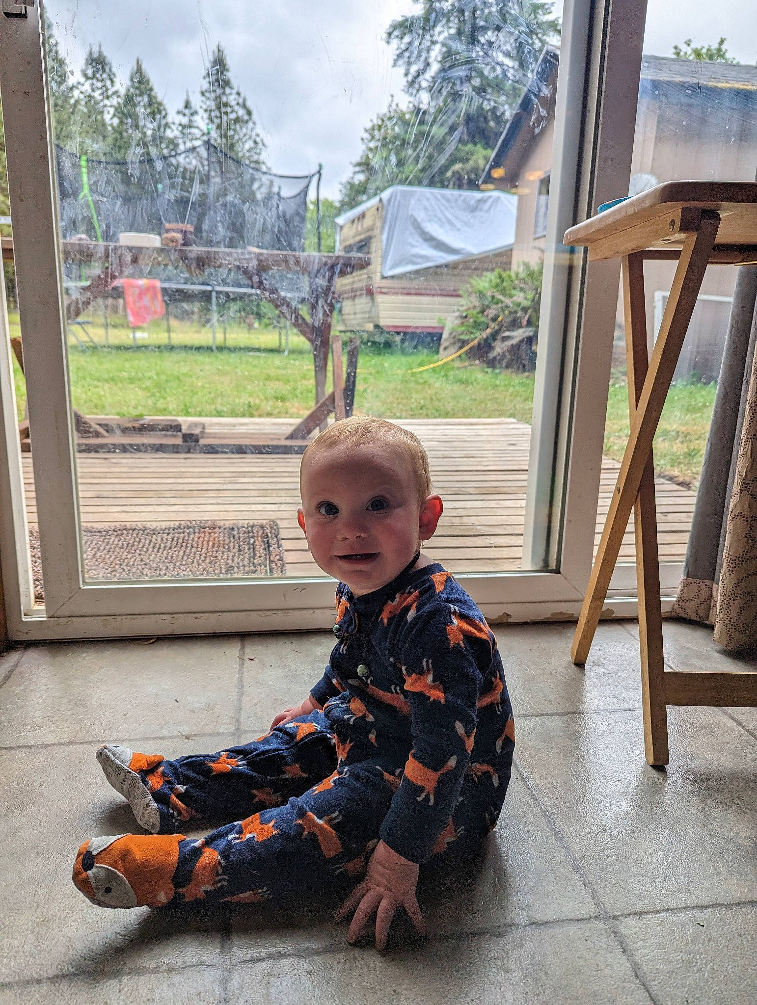 Westley is registered to the contest to win money with this photo: baby, child, design, floor, flooring, fun, grass, house, leisure, pattern, person, plaid, plant, room, shade, sitting, sky, toddler, tree, vacation