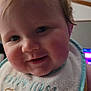 Giovanni joined the competition — help win amazing prizes! baby, close_up, face, smiling, blond_hair, bib, infant, child, cute, indoor, portrait, soft_light, young, happy, chubby_cheeks, person, head, apparel, text_on_clothing, warm