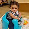 Ky'Son joined the competition — help win amazing prizes! toddler, baby_seat, child, curly_hair, smiling, indoor, toy, mirror, crib, carpet, blue, clothing, sock, happy, person, furniture, floor, play, cute, young_child