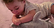 Ky'Son joined the competition — help win amazing prizes! baby, child, curly_hair, plush_toy, shark_toy, blanket, indoor, carpet, laundry_basket, table, chair, floor, cute, infant, toddler, soft_toy, person, crawling, playtime, home