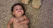 Ky Son is registered to the contest to win money with this photo: baby, carpet, child, cute, diaper, floor, happy, horns, indoor, infant, lying_down, person, playful, plush, smile, sock, soft_texture, stuffed_animal, toy, young_child