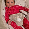 baby, infant, red_onesie, bunny_theme, baby_seat, cute, smiling, child, indoors, plush, face, person, comfort, relaxing, holiday, patterned_clothing, small_hands, footed_pajamas, seated, young_child