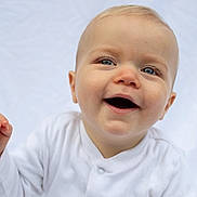 Albie is registered to the contest to win money with this photo: baby, baby_girl, blue_eyes, child, close_up, cute, expression, face, happy, head, human, infant, innocence, light_background, one_person, portrait, skin, smiling, white_clothing, young_child