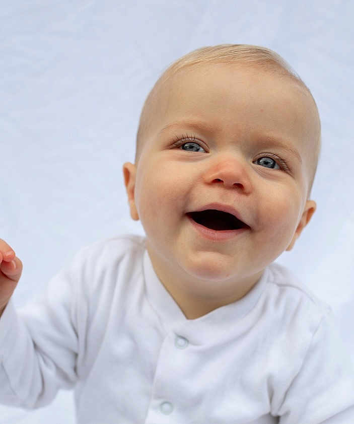 Albie is registered to the contest to win money with this photo: baby, baby_girl, blue_eyes, child, close_up, cute, expression, face, happy, head, human, infant, innocence, light_background, one_person, portrait, skin, smiling, white_clothing, young_child