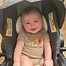 baby, smiling, stroller, winnie_the_pooh, toy, indoor, child, person, floor, footwear, sandals, wood_floor, cute, infant, clothing, seat, happy, playtime, colorful, casual