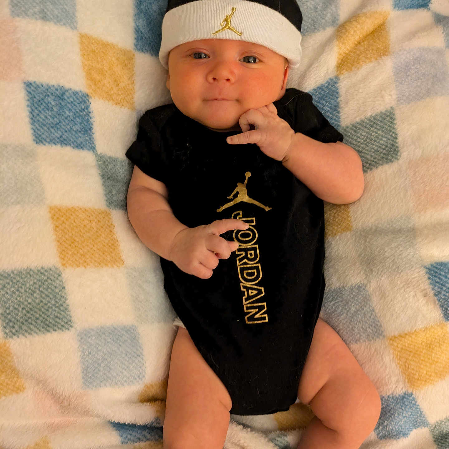 Lukas is registered to the contest to win money with this photo: baby, beanie, bed, blanket, bodypart, bonnet, cap, clothing, couch, face, finger, furniture, hand, hat, head, newborn, pants, person, photography, portrait