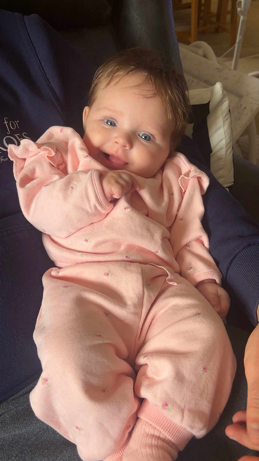 Lily-Mae joined the competition — help win amazing prizes! baby, infant, smiling, pink_clothing, floral_pattern, person, indoor, arm, happy, cute, child, soft_fabric, comfort, portrait, young, sitting, skin, face, hand, cozy